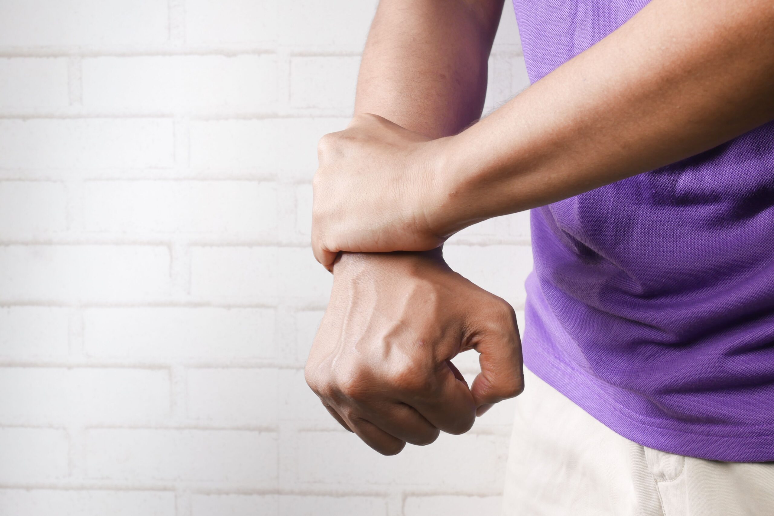 Person holding a painful wrist joint
