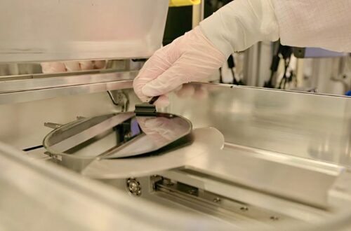 Semiconductor wafer being removed from processing equipment in a cleanroom
