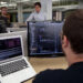 Engineers working at multiple code screens